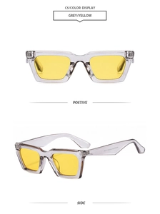 Détail de lunettes rétro carrées avec monture grise, verres jaunes et rivets métalliques
