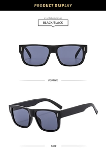 Close-up of classic black rectangular sunglasses with blue-gray lenses and metal stud details