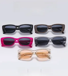 Flat lay detail showing five colors of rectangular frames with metal dot accents