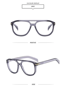 Detail view of grey transparent pilot eyewear frame with golden arrow metal accents