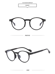 Close-up detail of retro oval black sunglasses with silver rivet accents and smooth finish