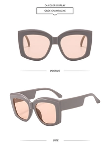 Detail view of large square grey sunglasses with wide temples and champagne tinted lenses