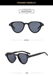 Macro shot of black square sunglasses with metallic rice rivets and dark lenses