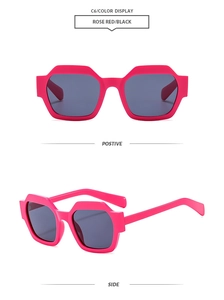 Detail view of bold rose red polygonal sunglasses with thick frames and dark lenses