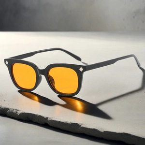 Retro square sunglasses with orange lenses and silver studs casting a colorful shadow
