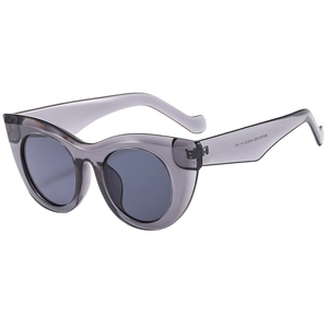 Thick cat-eye sunglasses in transparent grey finish with wide frame design at 45-degree angle