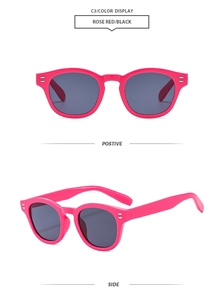 Detail of rose red round frame sunglasses with silver rivets and dark polarized lenses