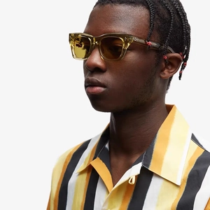 Fashion cat eye sunglasses with transparent yellow frame and dark tea lenses on model