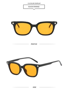 Detail of square black sunglasses with orange lenses and silver diamond rivets