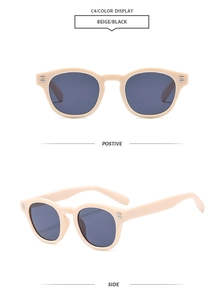 Detail view showing beige retro round frame sunglasses with silver rivet accents