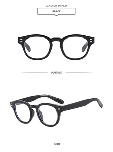 Detail view of black round frame sunglasses with silver stud accents and glossy finish