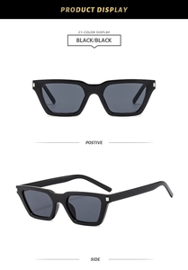 Detail view of black rectangular sunglasses with silver metal accents on the hinges
