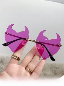 Close-up of frameless purple heart sunglasses with devil horns and gold metal bridge