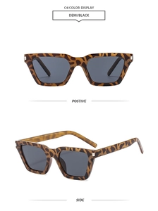 Detail view of tortoiseshell cat-eye square sunglasses with dark lenses and silver studs