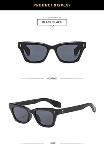 Detail of square cat-eye black sunglasses with silver arrow and dot metal accents