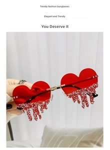 Detail of red heart sunglasses with sparkling rhinestone tassel and gold metal temples