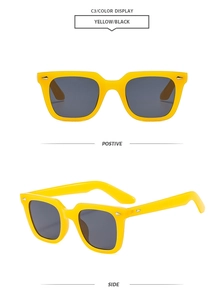 Detail view of square yellow retro sunglasses with silver arrow rivets and dark lenses