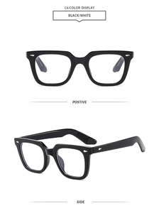 Detail view of square black sunglasses with silver diamond studs and white inner frame