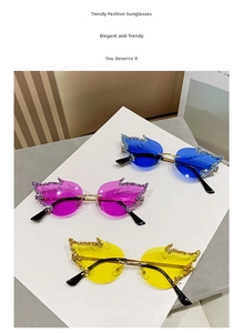Detailed view of three rimless flame sunglasses with rhinestones in blue purple and yellow