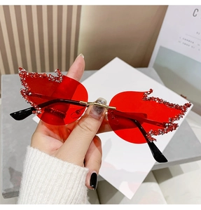 Detail of red flame-shaped rimless sunglasses with sparkling silver rhinestones edges