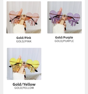 Detail of heart-shaped rimless sunglasses with dangling rhinestone tassels in multiple colors