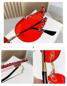 Close-up of red flame sunglasses featuring rhinestone-studded lenses and gold metal hinges