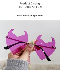 Detail of purple devil horn heart-shaped rimless sunglasses with gold metal bridge