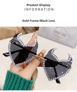 Detail of rimless heart-shaped sunglasses with gold bridge and crystal studs