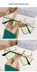Macro detail of rimless gold frame sunglasses with green lenses and sparkly rhinestones
