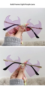 Detail of rimless devil heart sunglasses in light purple with gold metal frame