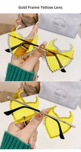 Close-up of yellow flame lenses with crystal rhinestones on gold metal sunglasses