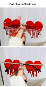 Detail of red heart sunglasses with sparkling rhinestone tassel and gold metal frame