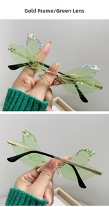 Detailed view of green dragonfly wing sunglasses with gold frames and pearl rhinestone accents