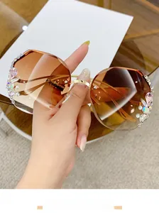 Detail of luxury rimless sunglasses featuring gradient lenses and sparkling rhinestone accents