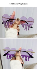 Detail of heart-shaped rimless sunglasses with purple lenses and teardrop rhinestone trim