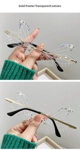Detail of dragonfly wing sunglasses with gold metal frame and crystal pearl accents
