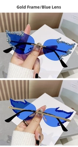 Detail of gold-framed blue butterfly sunglasses with sparkling rhinestone edges