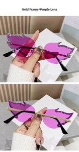 Close-up of rimless flame-shaped purple sunglasses with sparkling crystal edges