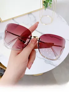 Detailed view of luxury rimless sunglasses with purple gradient lenses and gold metal frame