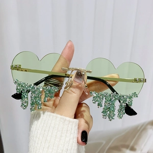 Chic heart-shaped rimless sunglasses with green lenses and decorative dripping rhinestones