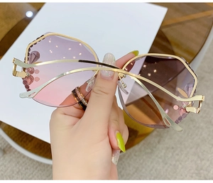 Detail of pink gradient lenses with shimmering rhinestones and gold metal temples