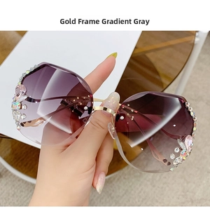 Close-up of gold metal frame sunglasses with gradient lenses and luxury rhinestone decor