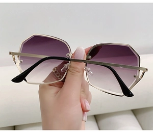 Macro detail of geometric gold metal frame sunglasses with purple gradient lenses