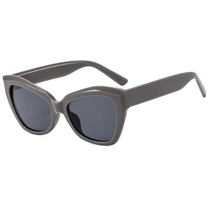 Retro cat-eye sunglasses with thick grey frames and dark lenses for women and men