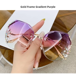 Close-up of golden half-frame sunglasses with gradient purple lenses and crystal floral accents