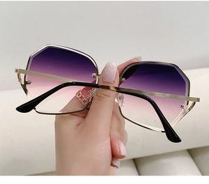 Detail of octagonal sunglasses showing gradient purple lenses and gold metal frame