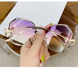Close-up of luxury oversized rimless sunglasses with purple gradient lenses and crystals
