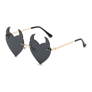 Fashionable heart-shaped devil horn sunglasses with a gold metal frame on a white background
