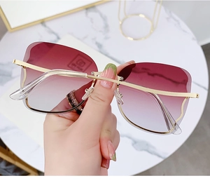 Detailed close-up of rimless gradient purple lenses and golden metal temples sunglasses