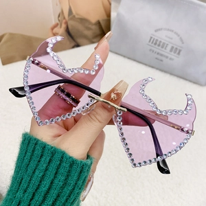 Frameless flame-shaped sunglasses with purple lenses and rhinestone trim for women